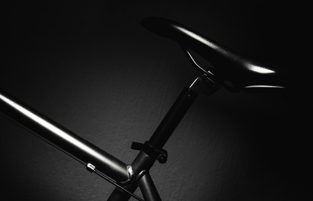 Part of a sport and modern bicycle in dark, accentuated shapes with lights.の写真素材