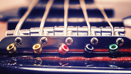 Closeup view on details of strings of jazz bass guitar.の写真素材