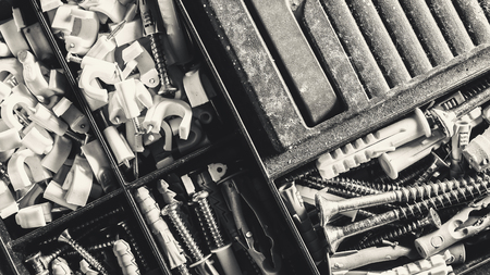 Old suitcase for nails and screws, part of a tools, closeup macro view.の写真素材