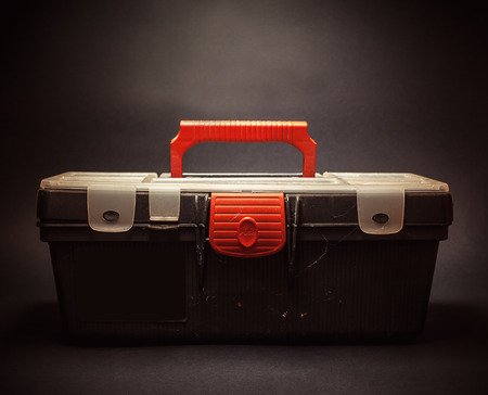 Details of an old dusty case for tools, closeup view on black background.の写真素材