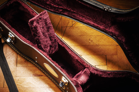 Old opened retro acoustic guitar suitcase on parquet. Details of interior.の写真素材