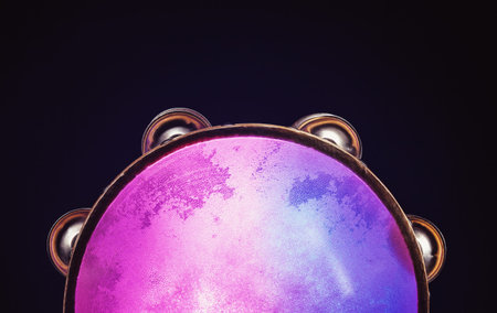 Details of a wooden tambourine, colorful illumination accentuate shapes and material.
