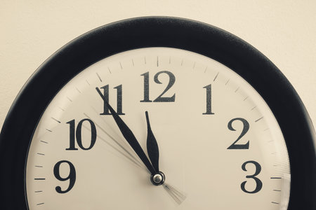 Details of a dusty clock on the white wall, retro style.