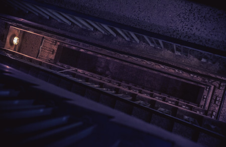 Dark ambiance of an old building interior, details of a staircase and lights. の写真素材