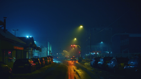 Outdoor scenes of dark streets during night, winter season. Traffic moments of a small Balkan town.の写真素材