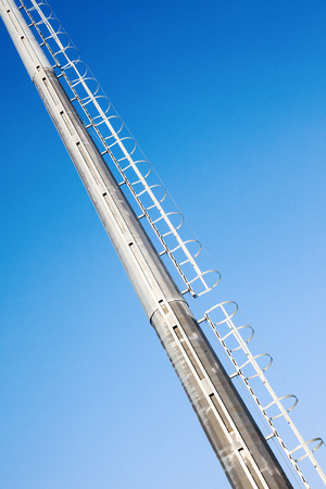 Details of big metal ladders, blue sky in background. の写真素材