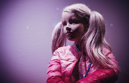 Details of a young girl doll dressed as for winter or fall season. の写真素材