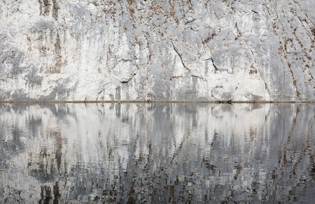 Abstract composition of water and mountain, reflections and stone.の写真素材