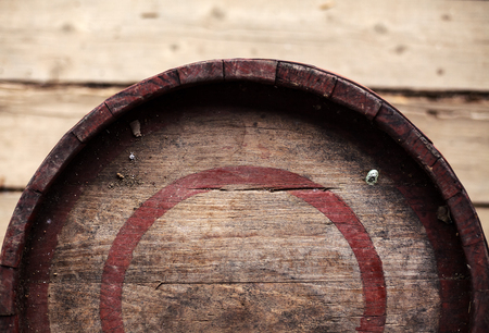 Old wooden barrel with red rings, closeup view from above.の写真素材