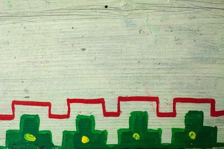Details of an old wooden plank with some decoration painted in style of Serbian village.の写真素材
