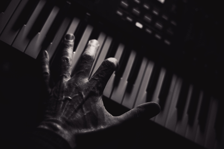 Closeup view of modern midi keyboard, dark background and strong highlights. の写真素材