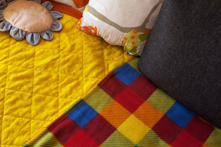 Details of colorful blankets and pillows, closeup view.