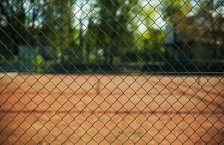 Closeup view on metal fence of tennis court.の写真素材