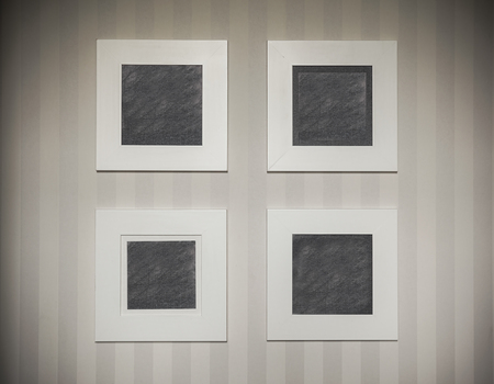 Abstract composition of four empty picture frames on modern but simple wallpapers.の写真素材