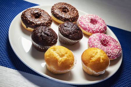 Various colorful chocolate cakes on white plate.の写真素材