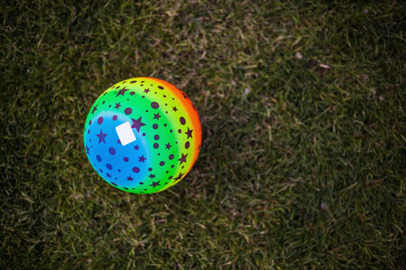 View on colorful kid's ball on green grass.の写真素材