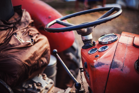Closeup view on tractor's seat and steering wheel.の写真素材