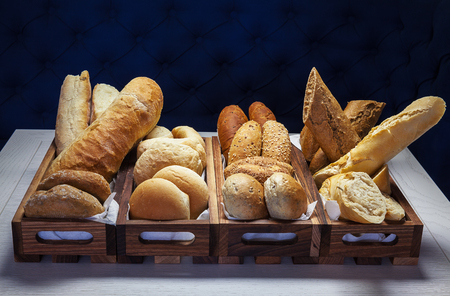 A lot of various pastry and bread on table.の写真素材