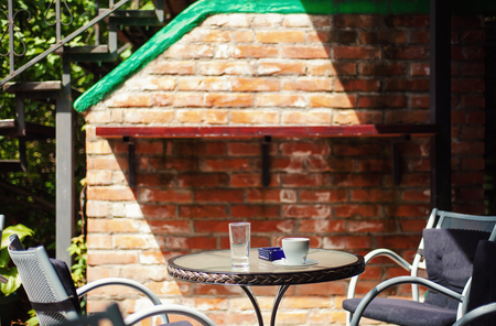 One table, two metal armchairs and empty coffee cup.の写真素材