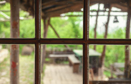 Closeup view on part of an old retro window, wooden frame and dirty glass details.の写真素材