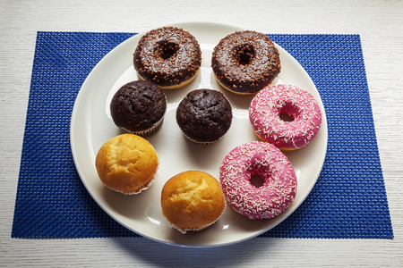 Various colorful chocolate cakes on white plate.の写真素材