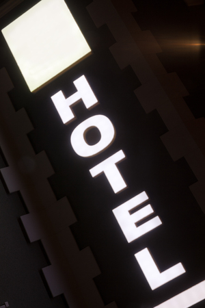 Abstract composition of illuminated text of hotel with empty square.の写真素材