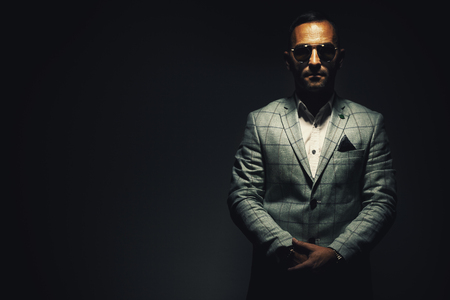 Portrait of an adult man blue striped jacked and blue sunglasses.の写真素材