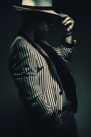 Portrait of a man wearing striped jacket and hat.の写真素材