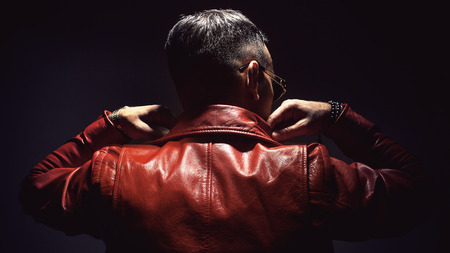 Adult man in red leather jacket, view from back.の写真素材