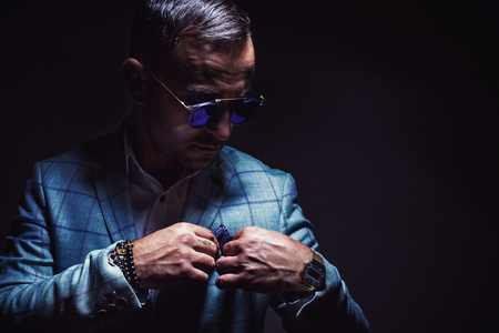 Portrait of an adult man blue striped jacked and blue sunglasses.の写真素材