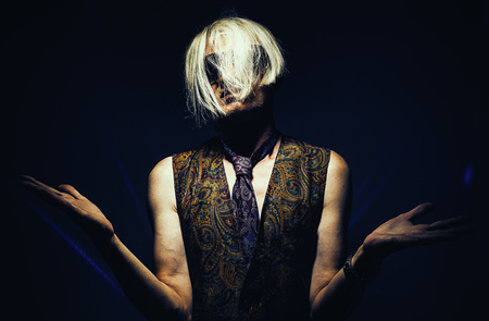 Middle aged man in colorful clothes and sunglasses, with modern haircut.の写真素材
