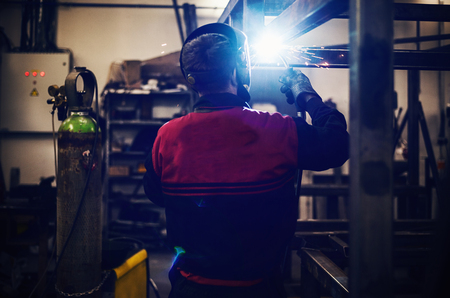 Worker in big industrial company, welding and grinding.の写真素材
