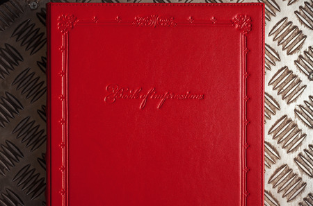 Closeup view of red leather book of impressions.の写真素材