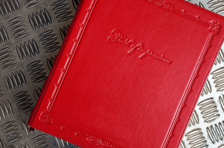 Closeup view of red leather book of impressions.の写真素材
