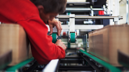 Man on industrial machine, production line details. の写真素材