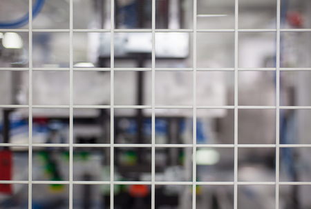 Abstract composition of white metal net, industrial blurry background.の写真素材