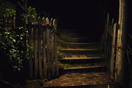 Entrance to household, wooden fence details during night.の写真素材
