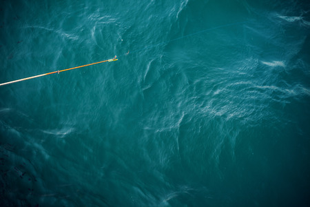 Details of fishing stick above sea water.の写真素材