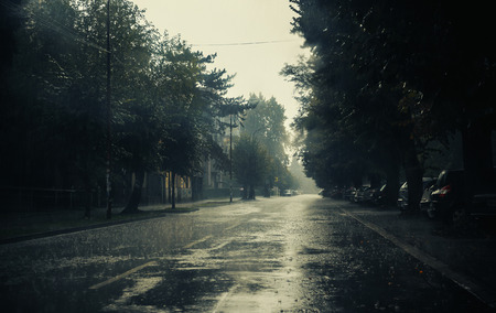 Heavy autumn rain in small Balkan town, weather moments.の写真素材