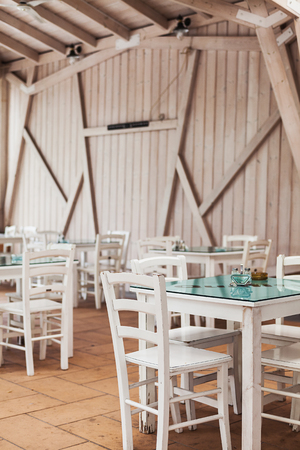 One part of wooden restaurant balcony, view on chairs and tables.の写真素材
