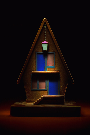 Little wooden house as souvenir, studio shot in dark.の写真素材