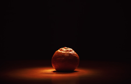 Studio shot of fresh mandarin on orange surface.の写真素材