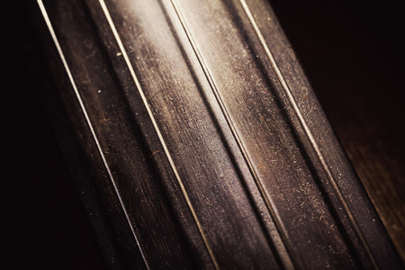 Closeup view of an old dusty cello, accentuated shapes with light. の写真素材