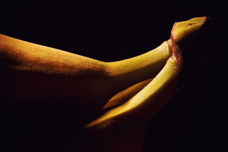Studio shot of fresh banana, accentuated shapes with illumination. の写真素材