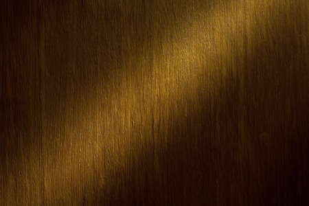 Interesting illuminated part on wooden surface, details of texture.  の写真素材