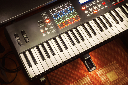 Details of modern midi keyboard in small home studio.の写真素材