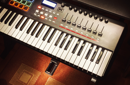 Details of modern midi keyboard in small home studio.の写真素材