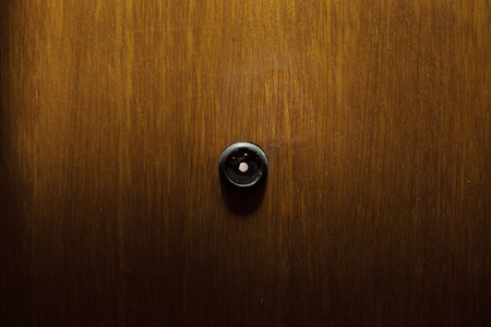 Old peephole in wooden doors, abstract composition. の写真素材