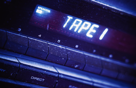 Closeup view of old dusty black tuner, details of display with tape and speaker displayed. の写真素材
