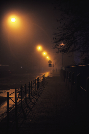 Night scene from small Balkan town, foggy atmosphere.  の写真素材